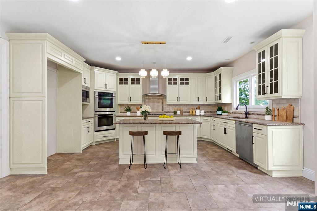 767 Orangeburgh Road River Vale, NJ 07675 - Photo 14 of 49 a kitchen with kitchen island granite countertop lots of counter top space and stainless steel appliances