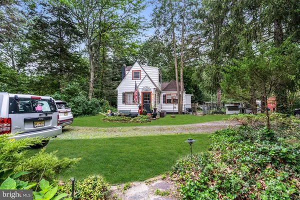 a view of a chair and table in backyard of the house