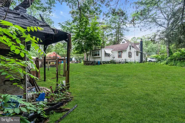 a view of a house with backyard sitting area and garden