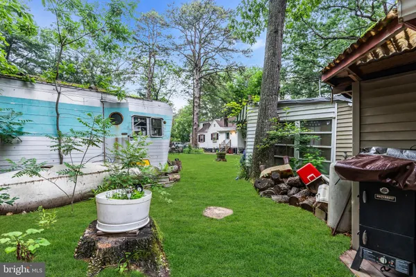 a view of a chairs and table in backyard