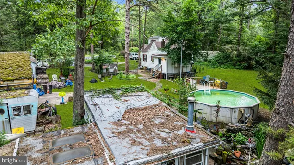 a car parked in front of a house with a garden