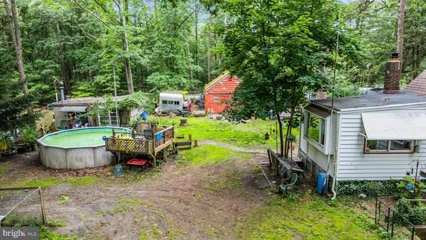 a view of house with backyard space and garden