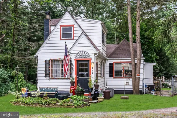 a car parked in front of a house with a small yard