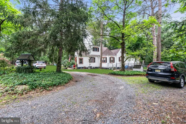 a view of a house with a yard and sitting area