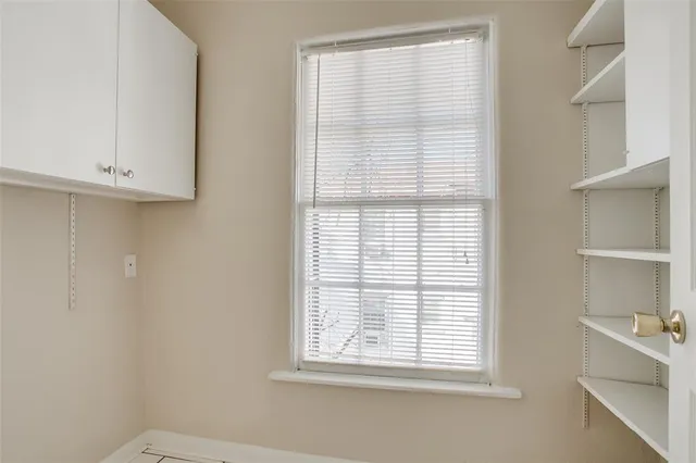 a kitchen with granite countertop white cabinets and sink