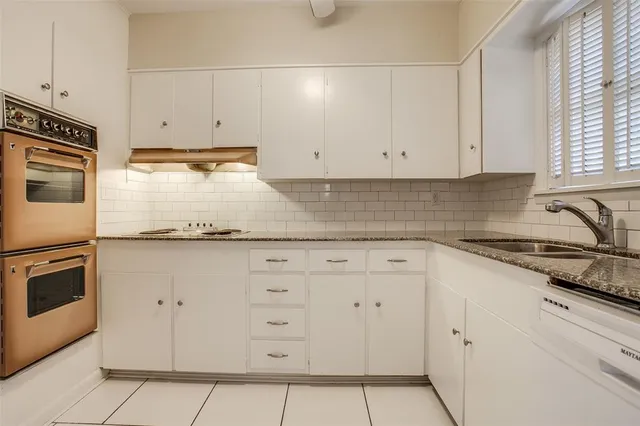 a kitchen with granite countertop a stove and a microwave