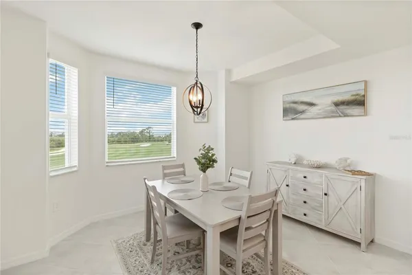 a bedroom with a bed and a lamp on dresser