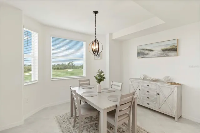 a bedroom with a bed and a lamp on dresser