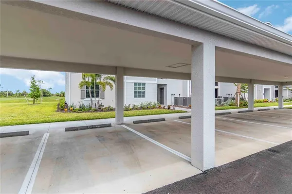 a living room with furniture kitchen and a chandelier