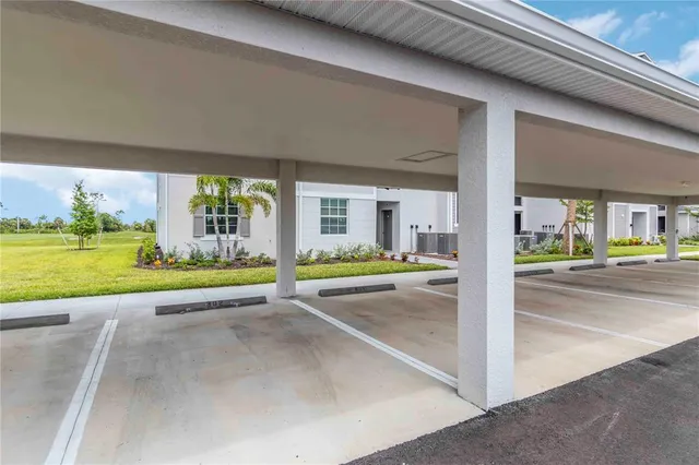 a living room with furniture kitchen and a chandelier