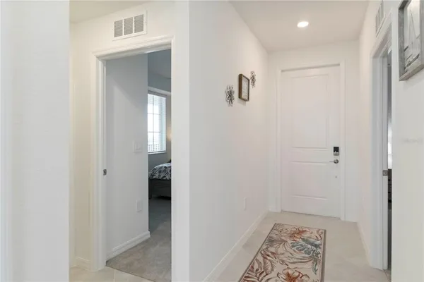 a living room with furniture a chandelier and a dining table