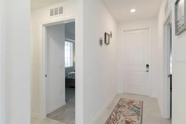 a living room with furniture a chandelier and a dining table