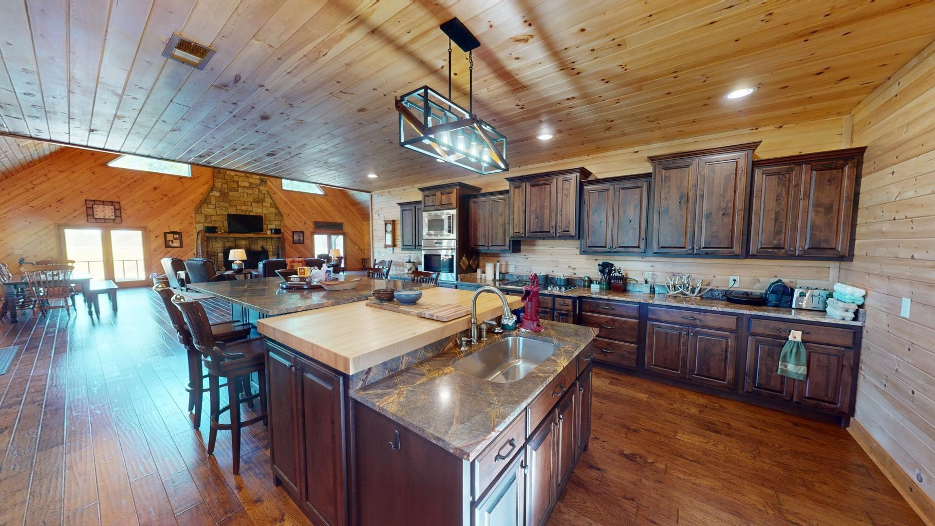 5334 Ira Barker Road Obion, TN 38240 - Photo 15 of 68 a kitchen with stainless steel appliances granite countertop a table chairs and wooden floors