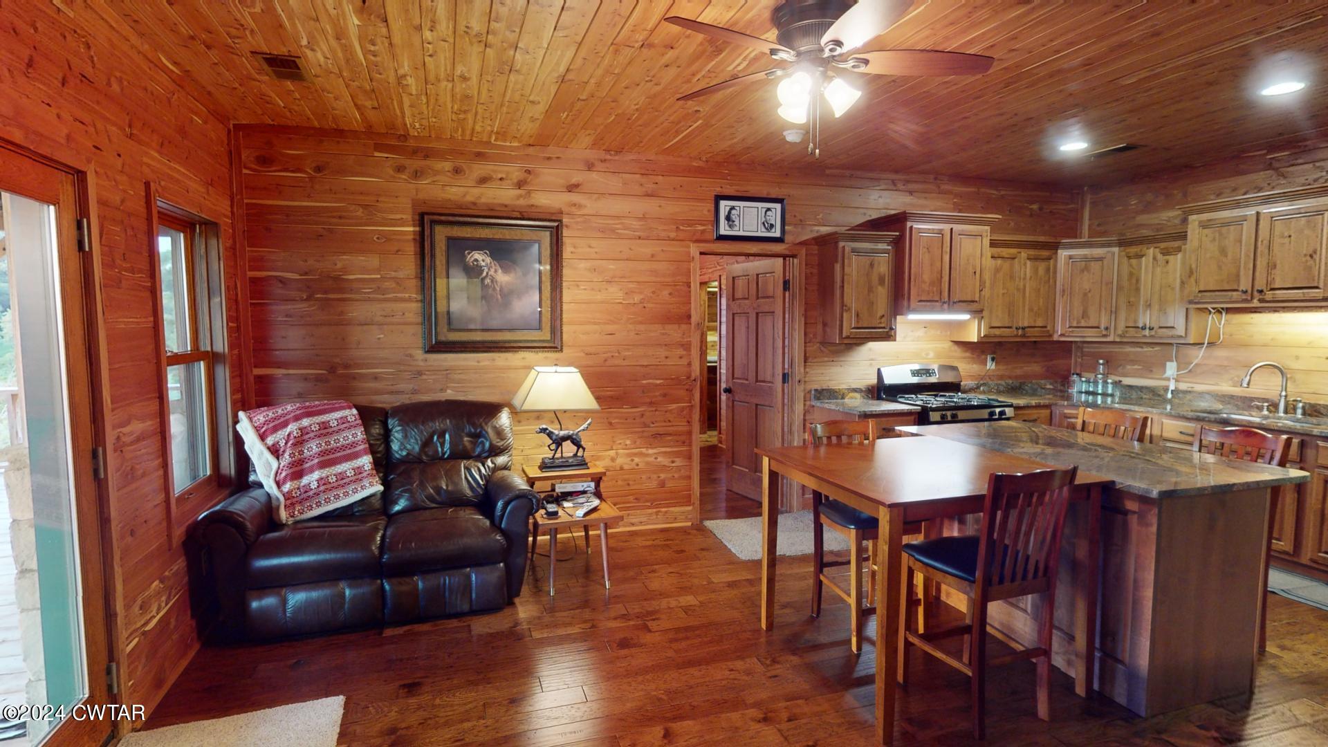 5334 Ira Barker Road Obion, TN 38240 - Photo 22 of 68 a living room with stainless steel appliances kitchen island granite countertop furniture and a wooden floor