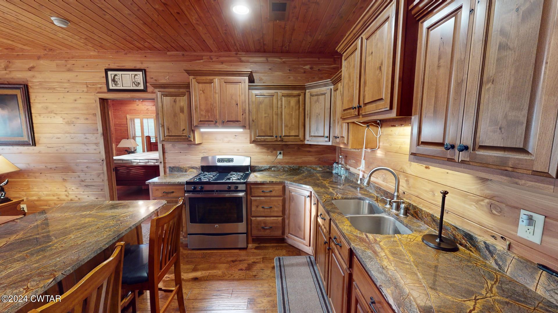 5334 Ira Barker Road Obion, TN 38240 - Photo 24 of 68 a kitchen with wooden cabinets and stainless steel appliances