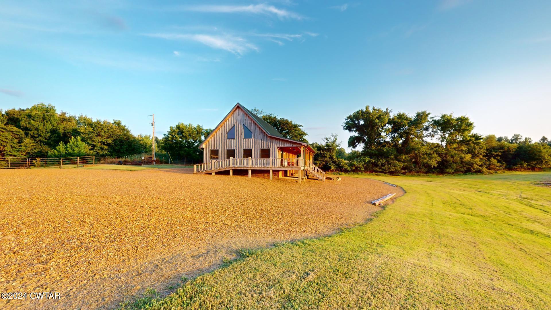 5334 Ira Barker Road Obion, TN 38240 - Photo 36 of 68 a front view of house with yard and trees in the background