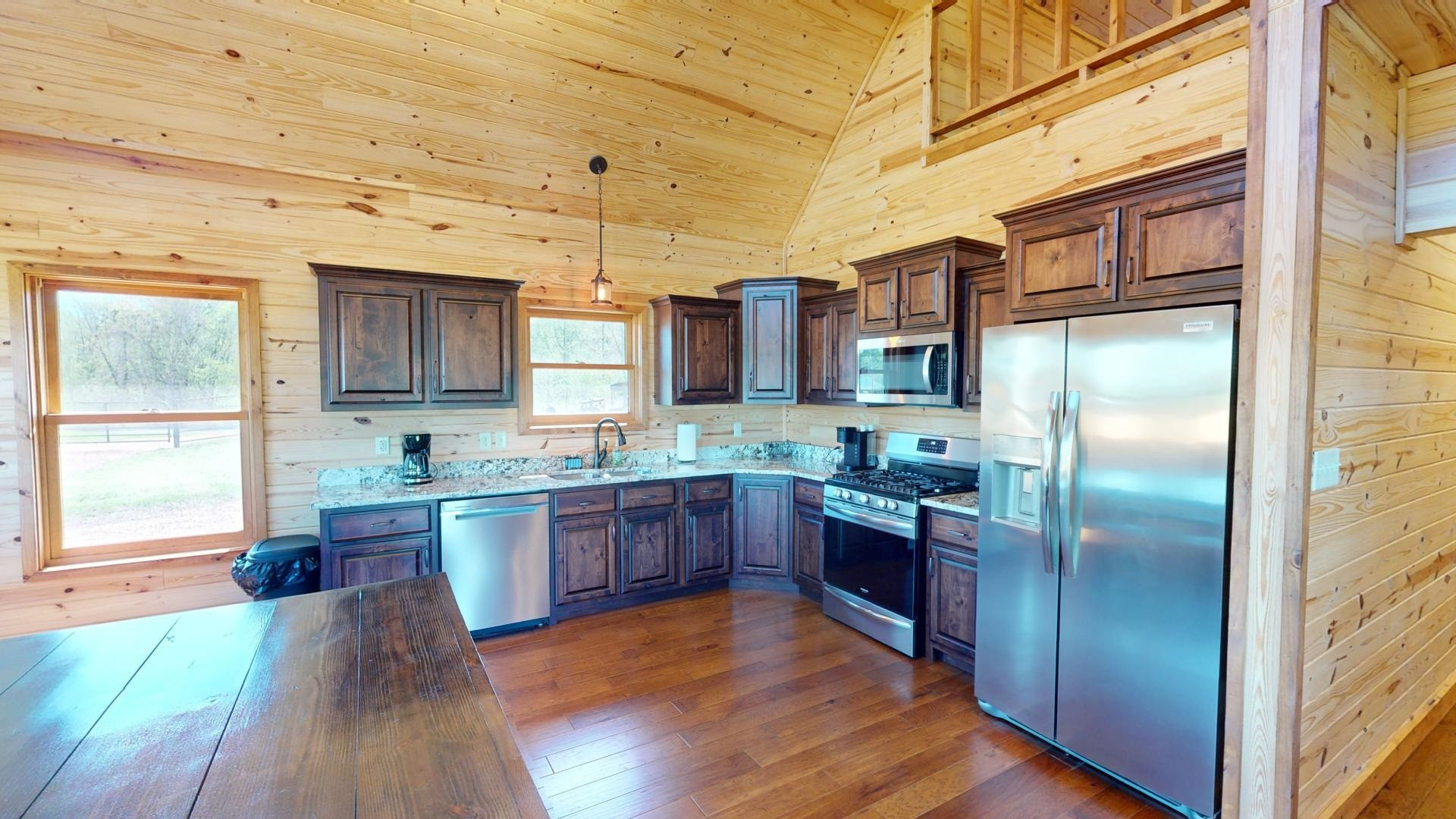 5334 Ira Barker Road Obion, TN 38240 - Photo 39 of 68 a kitchen with stainless steel appliances granite countertop a refrigerator a sink dishwasher a oven with wooden cabinets and floor