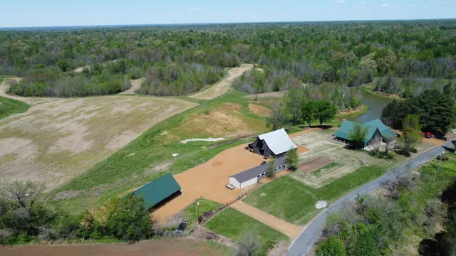 an aerial view of a house with pool outdoor space and garden