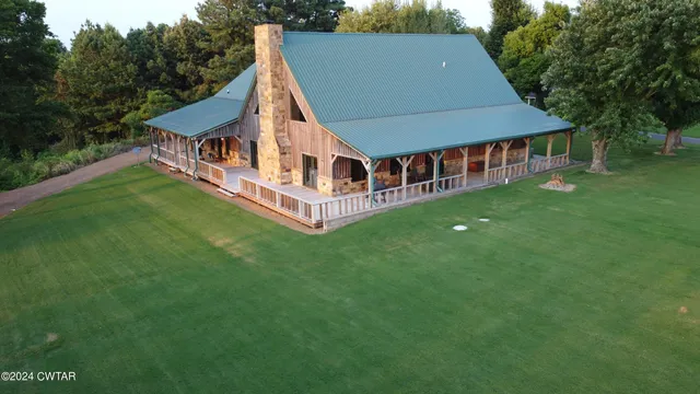 a aerial view of a house with a yard table and chairs