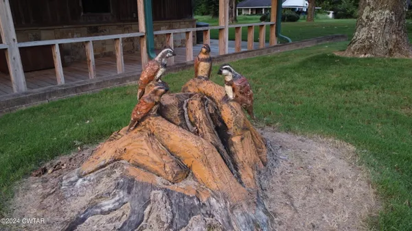 a view of a house with backyard and sitting area