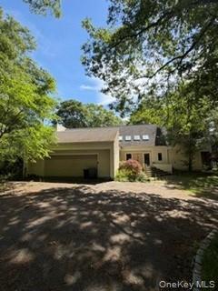 1117 Cedar Ridge Road Oyster Bay, NY 11771 - Photo 39 of 41 a front view of a house with a yard and garage