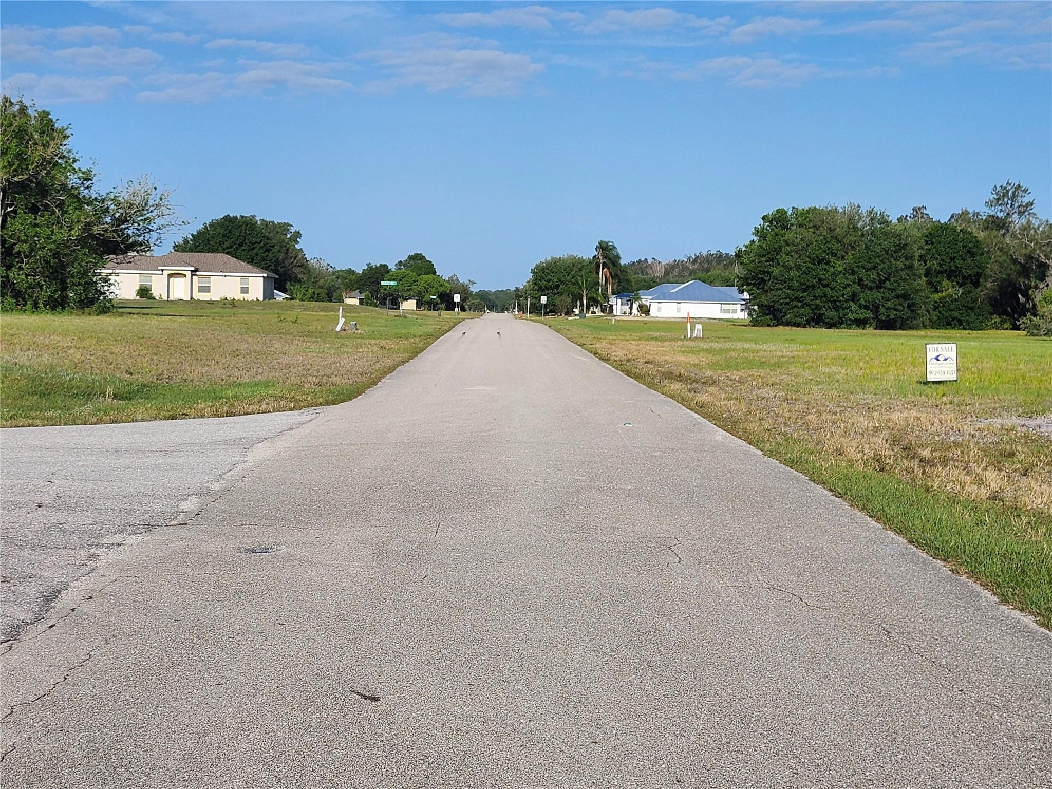 7933 Castile Road Sebring, FL 33876 - Photo 6 of 8 a view of a garden with a building in the background