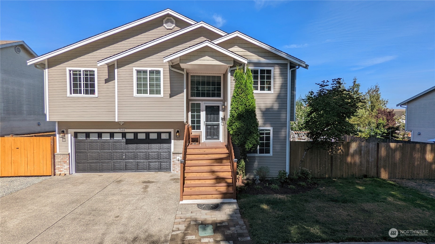 7508 Upper Ridge Road Everett, WA 98203 - Photo 1 of 26 a front view of a house with a yard and garage