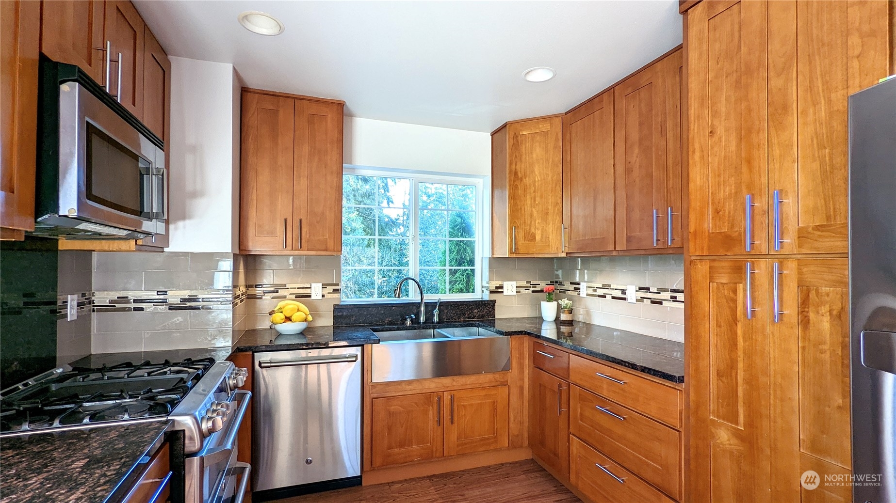 7508 Upper Ridge Road Everett, WA 98203 - Photo 6 of 26 a kitchen with stainless steel appliances a stove a sink a microwave cabinets and a counter top space