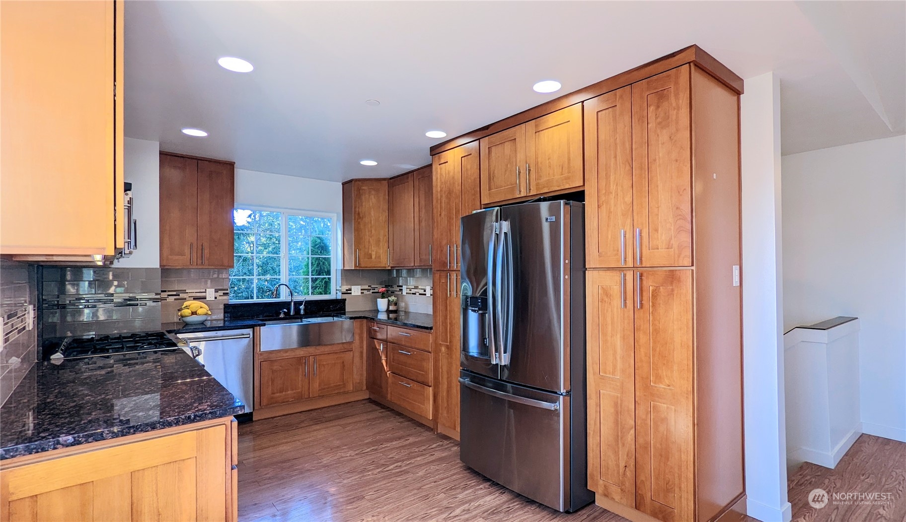 7508 Upper Ridge Road Everett, WA 98203 - Photo 8 of 26 a kitchen with sink a refrigerator and chairs