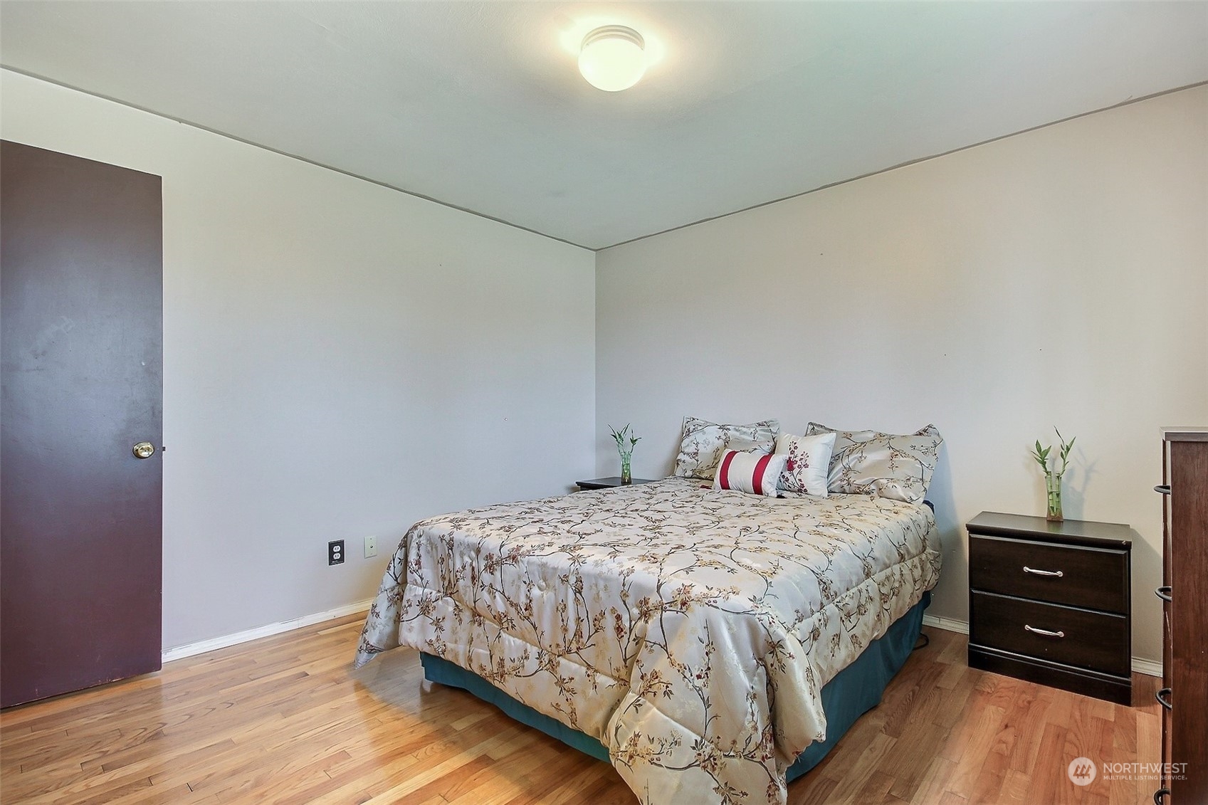 8605 Terrace Road Southwest Lakewood, WA 98498 - Photo 11 of 16 a bedroom with a bed and wooden floor
