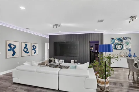 a living room with furniture and flowers
