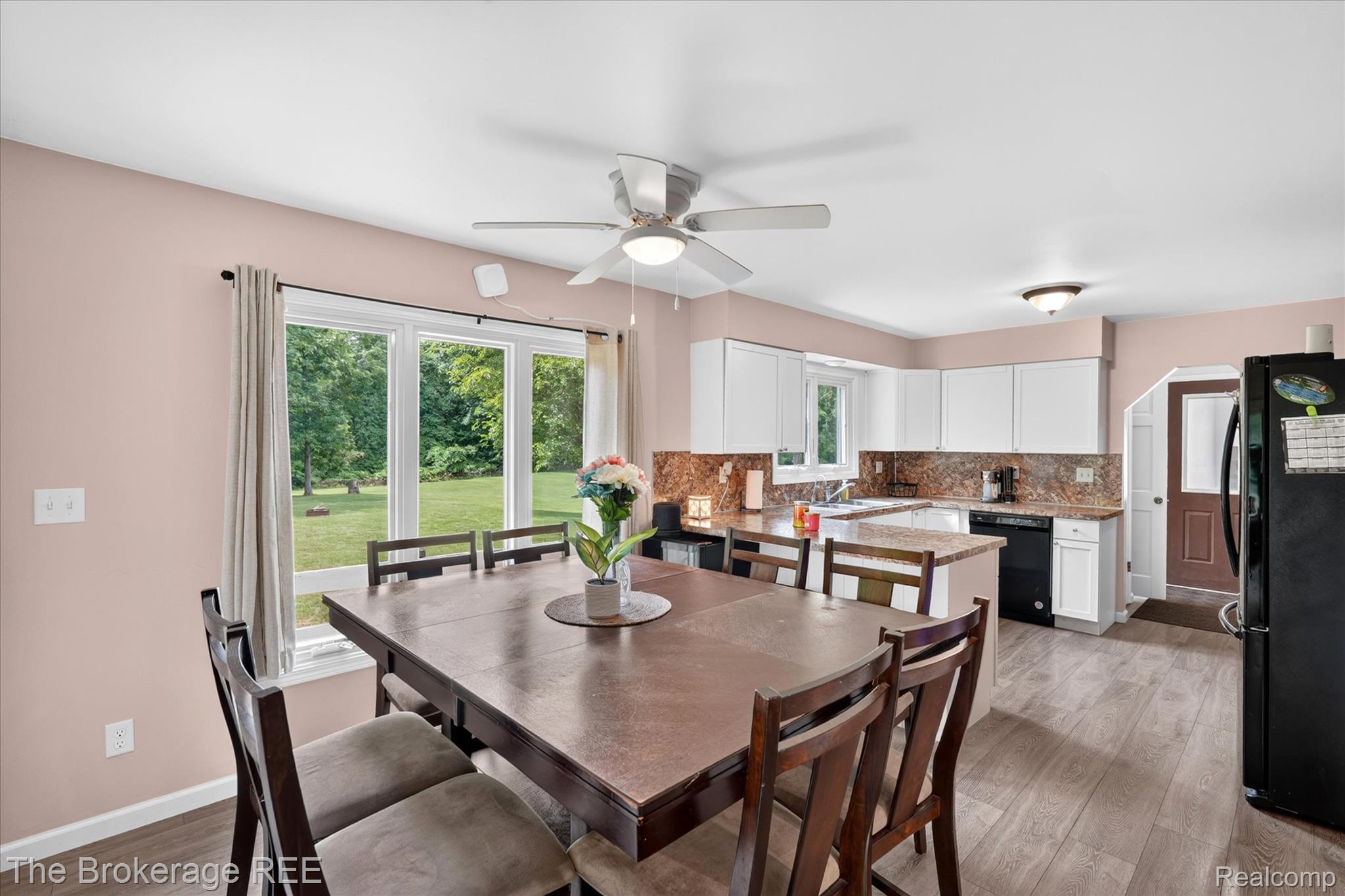 13269 North Genesee Road Clio, MI 48420 - Photo 15 of 67 Bright dining area with large windows, wood-finish flooring, and a ceiling fan