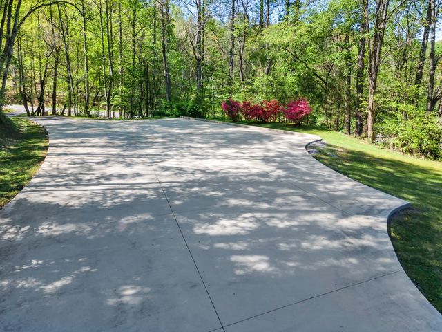 a front view of a house with a garden and patio