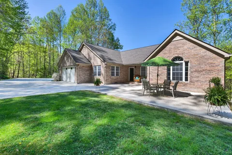 a view of a house with backyard and sitting area