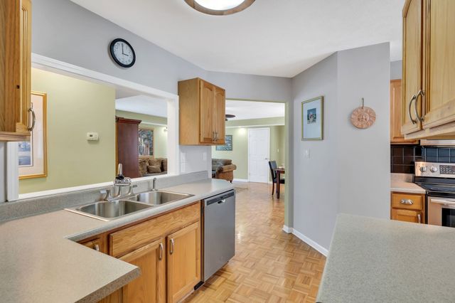 a kitchen with stainless steel appliances granite countertop a sink and cabinets