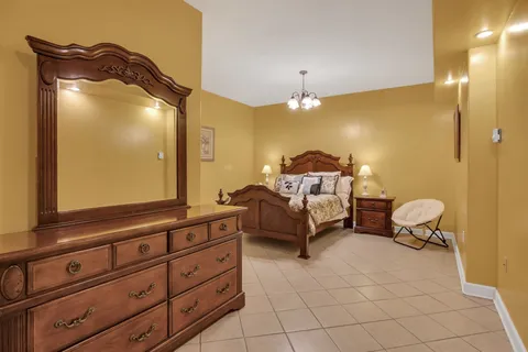 a view of an empty room with window and kitchen