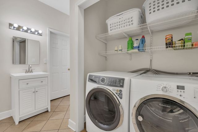 a front view of a house with yard and green space