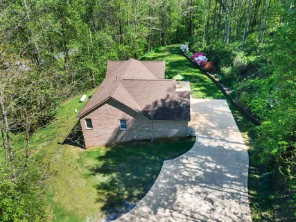 a view of a garden with a house