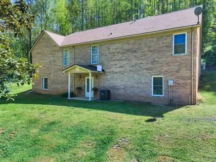 a view of a street with a bench and trees