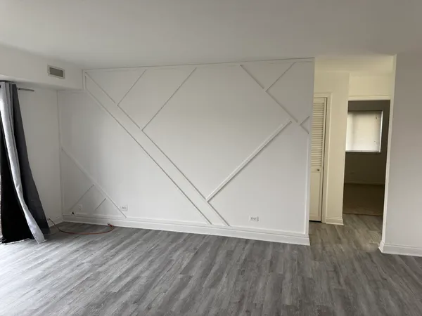 an empty room with wooden floor