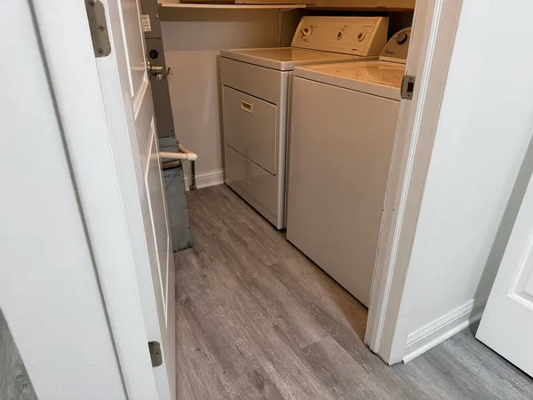 a view of a storage and utility room with a washer dryer