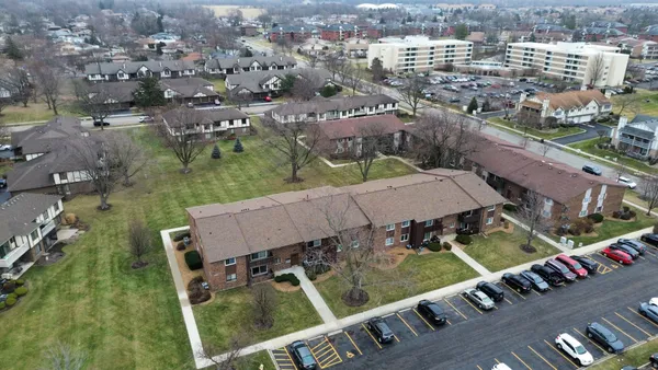 an aerial view of multiple houses with yard