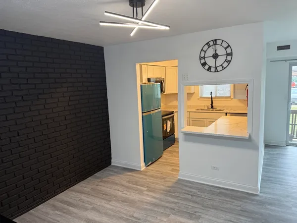 en empty room with window and wooden floor