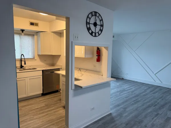 a view of a kitchen cabinets a sink and a stove top oven
