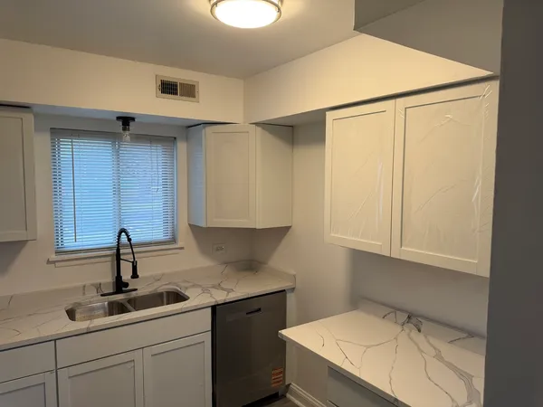 a kitchen with a sink and cabinets