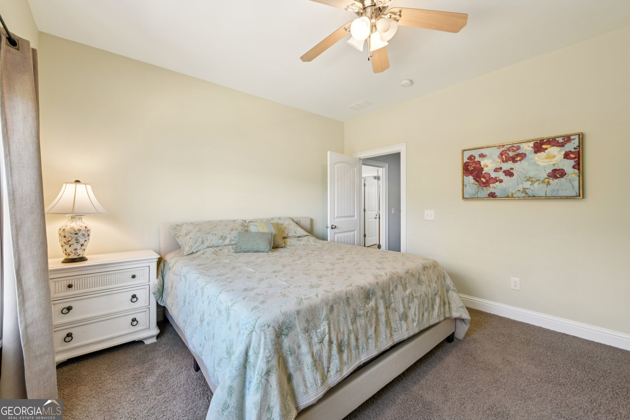 590 Ridge Road Dawsonville, GA 30534 - Photo 25 of 79 a bedroom with a bed and a chandelier