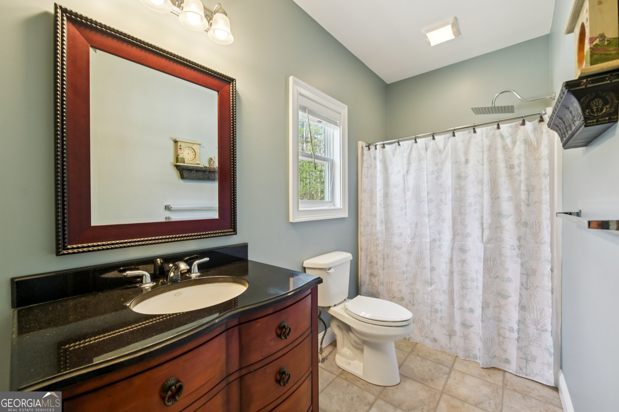 590 Ridge Road Dawsonville, GA 30534 - Photo 27 of 79 a bathroom with a granite countertop sink toilet a mirror and a shower