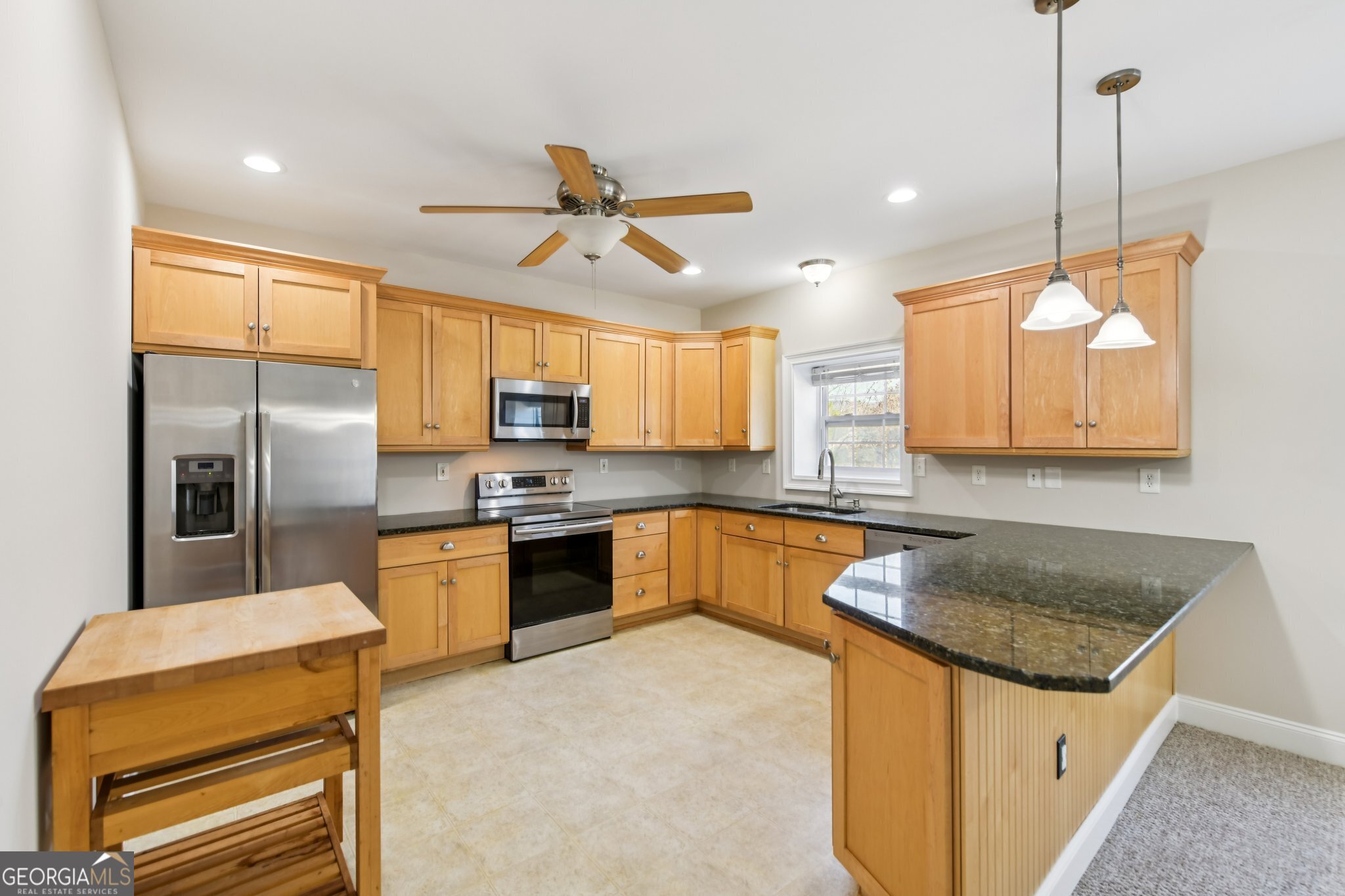 590 Ridge Road Dawsonville, GA 30534 - Photo 40 of 79 a kitchen with stainless steel appliances granite countertop a sink a stove and a refrigerator