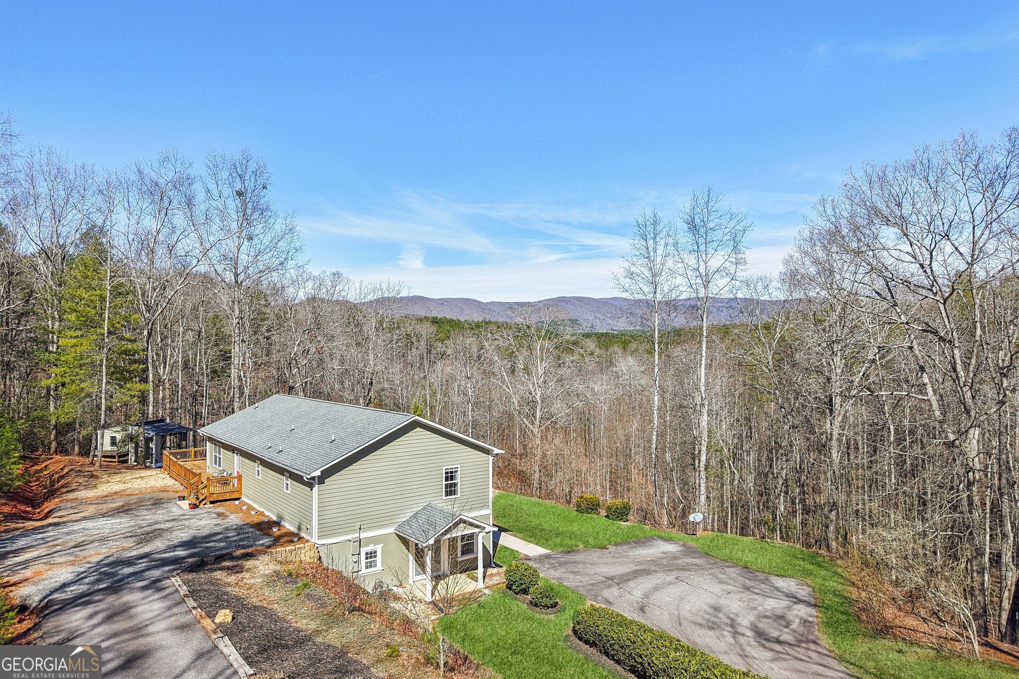 590 Ridge Road Dawsonville, GA 30534 - Photo 4 of 79 a view of a terrace with a garden and trees