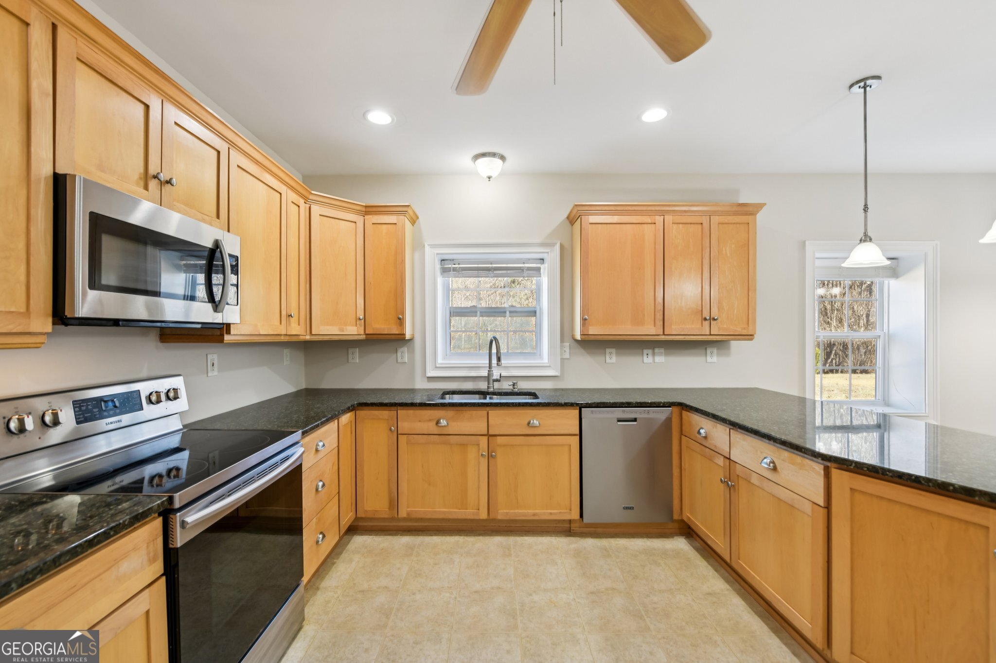 590 Ridge Road Dawsonville, GA 30534 - Photo 41 of 79 a kitchen with stainless steel appliances granite countertop a sink a stove and cabinets